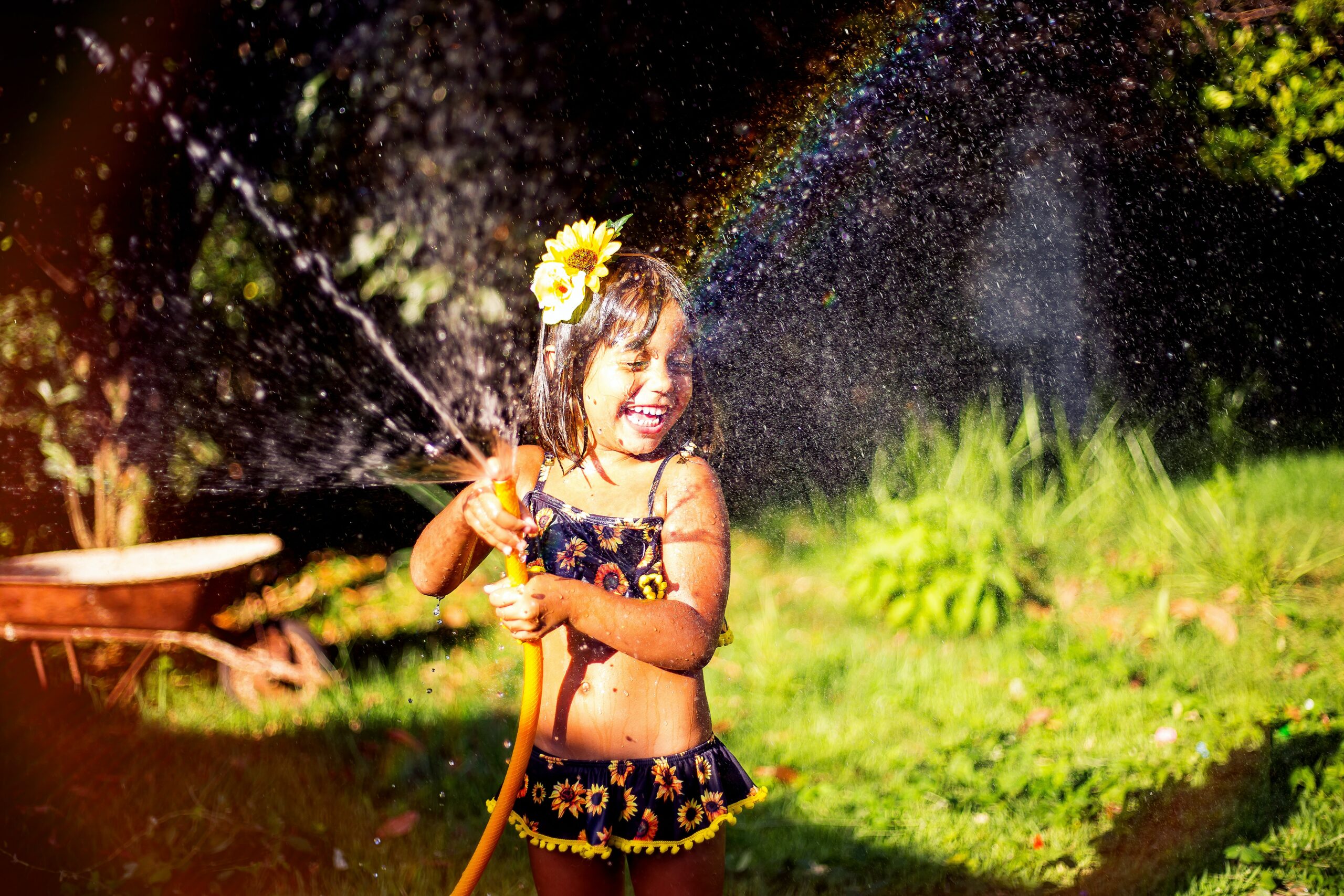 6 Mind-Blowing Backyard Science Experiments for Kids - Smiling Girl Playing With Water Hose 2168791 ScaleD